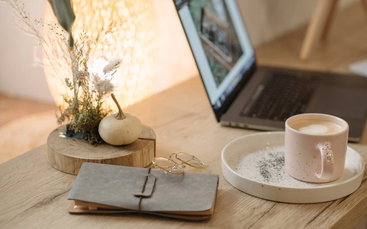 Image of a notebook, laptop and coffee
